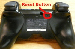 Back of PS3 controller showing reset button.